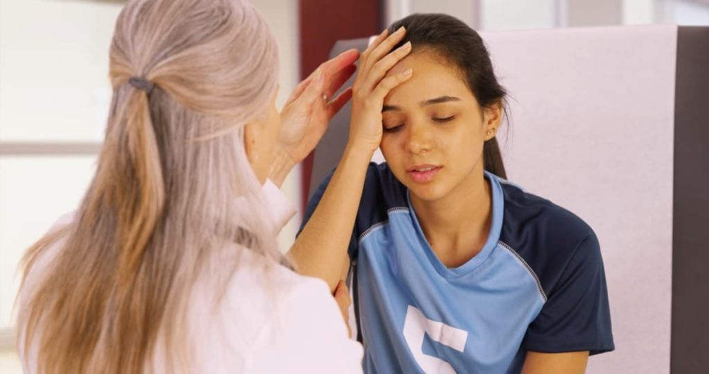 teenager with concussion consulting a doctor